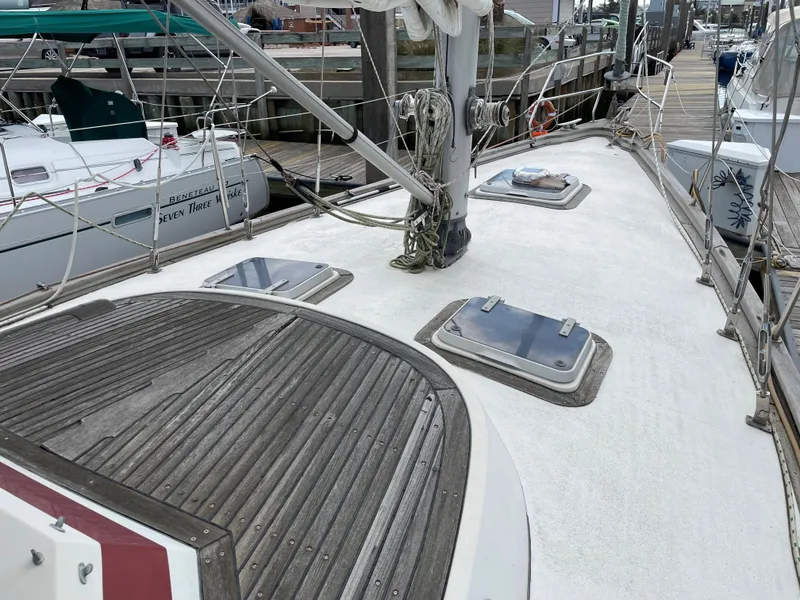 Slide: The Image of 1983 Najad 371 American CC sailboat deck with hatches and rigging at a marina. - 18