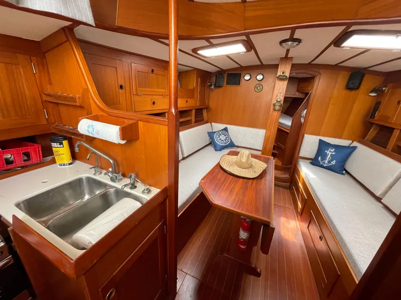 Slide: The Image of Interior of 1983 Najad 371 American CC sailboat with wooden finishes and cozy seating. - 19