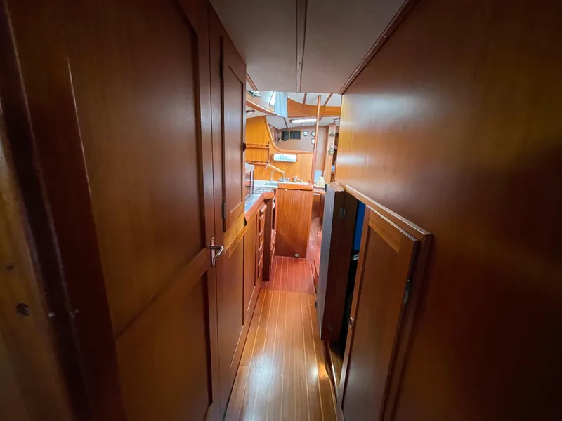 Slide: The Image of Interior of 1983 Najad 371 American CC sailboat with wooden cabinetry and flooring. - 24
