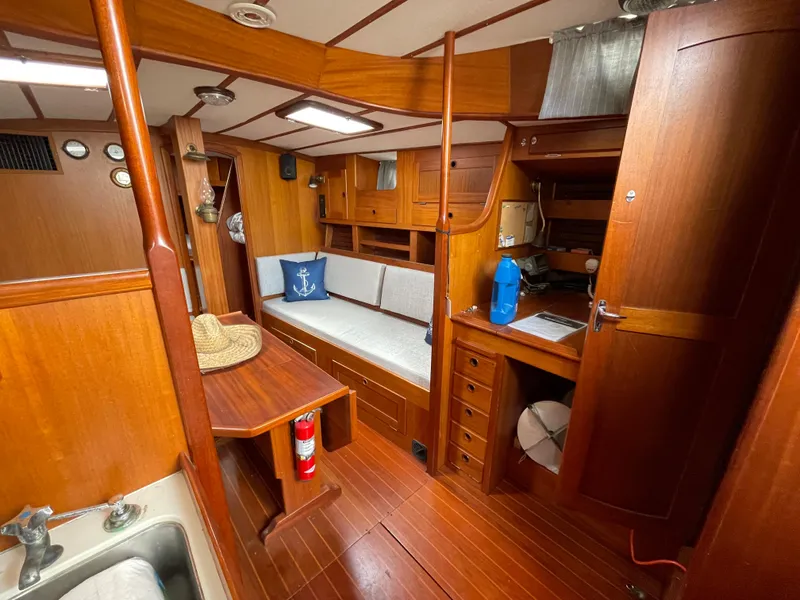 Slide: The Image of Interior of 1983 Najad 371 American CC sailboat with wooden furnishings and cozy seating. - 25