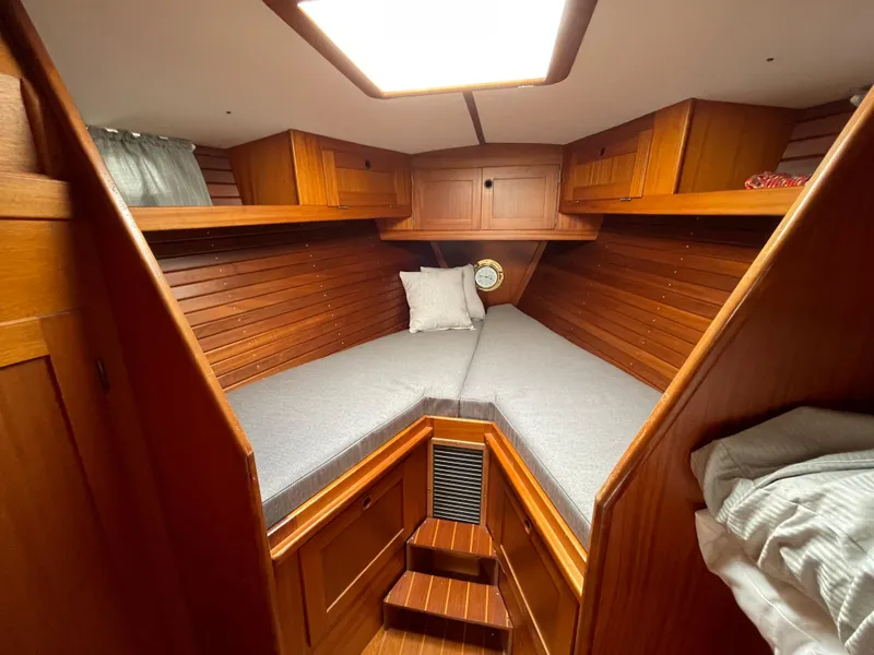 Slide: The Image of 1983 Najad 371 American CC cabin with wooden interior and cozy bedding. - 28