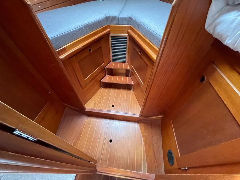 Slide: The Image of Interior cabin of 1983 Najad 371 American CC sailboat with wooden finish and cushioned seating. - 29