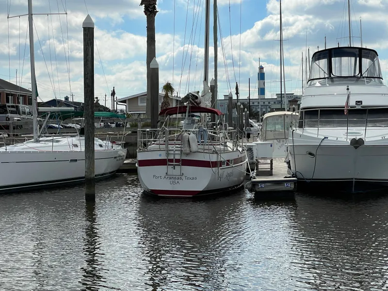 Slide: The Image of Najad 371 American CC 1983 sailboat docked at marina between two yachts. - 3