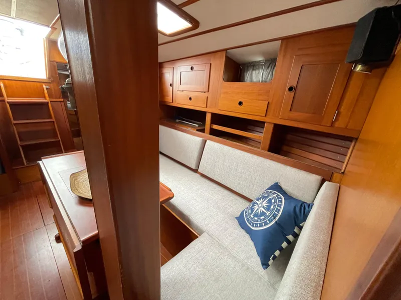 Slide: The Image of Interior of 1983 Najad 371 American CC sailboat with wooden cabinetry and cushioned seating. - 31