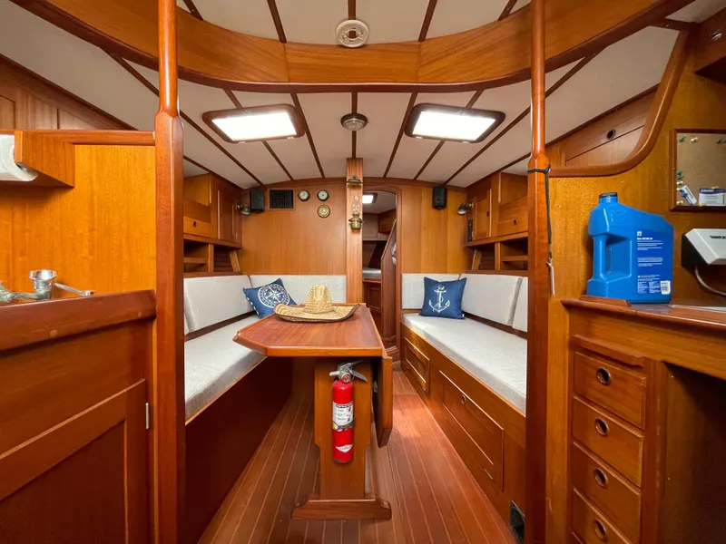 Slide: The Image of 1983 Najad 371 American CC sailboat interior with wooden furnishings and cozy seating area. - 32