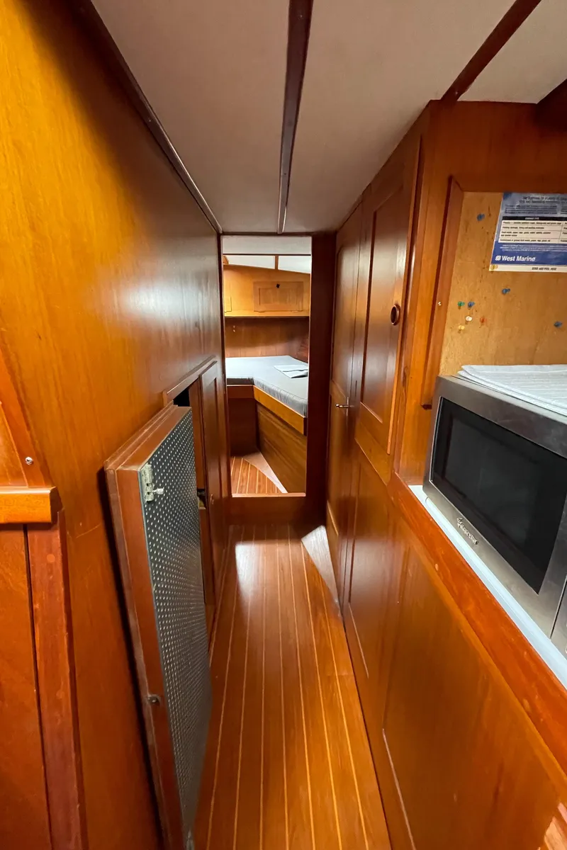 Slide: The Image of 1983 Najad 371 American CC interior with wooden paneling and galley. - 36