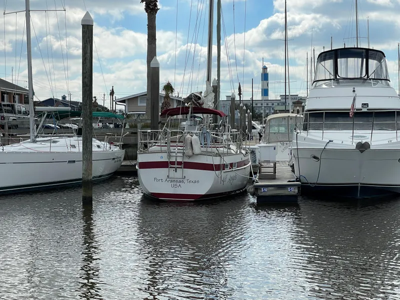 Slide: The Image of Najad 371 American CC 1983 sailboat docked at marina between two other boats. - 7