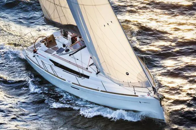 The Image of 2019 Jeanneau Sun Odyssey 389 sailing on open water, showcasing sleek design and performance. - 0