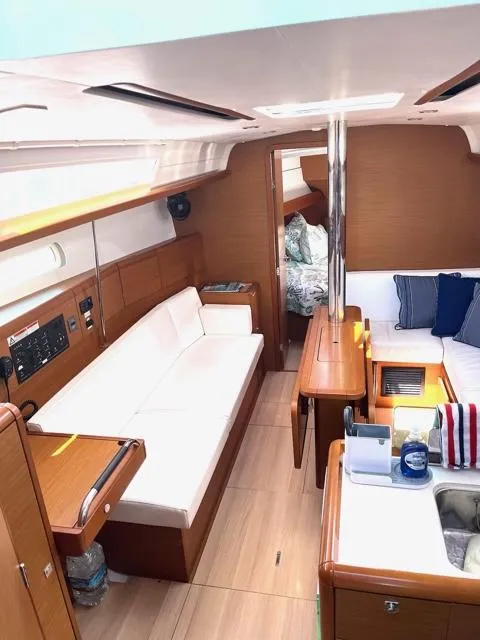 Slide: The Image of Interior of 2019 Jeanneau Sun Odyssey 389 sailboat with modern furnishings and cozy seating. - 16