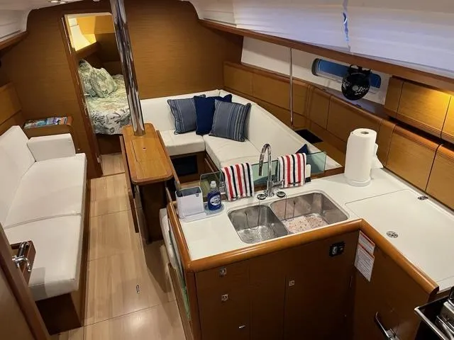 Slide: The Image of Interior of 2019 Jeanneau Sun Odyssey 389 yacht with modern kitchen and seating area. - 18