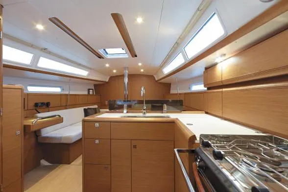 Slide: The Image of Interior of 2019 Jeanneau Sun Odyssey 389 yacht, featuring modern kitchen and seating area. - 6