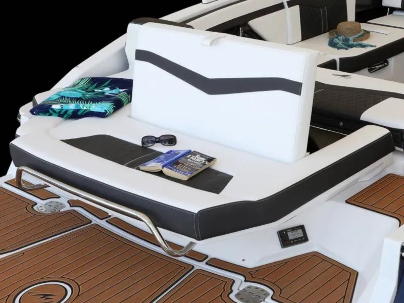 Slide: The Image of 2023 Monterey 278SS boat interior with white seating, book, sunglasses, and towel. - 3