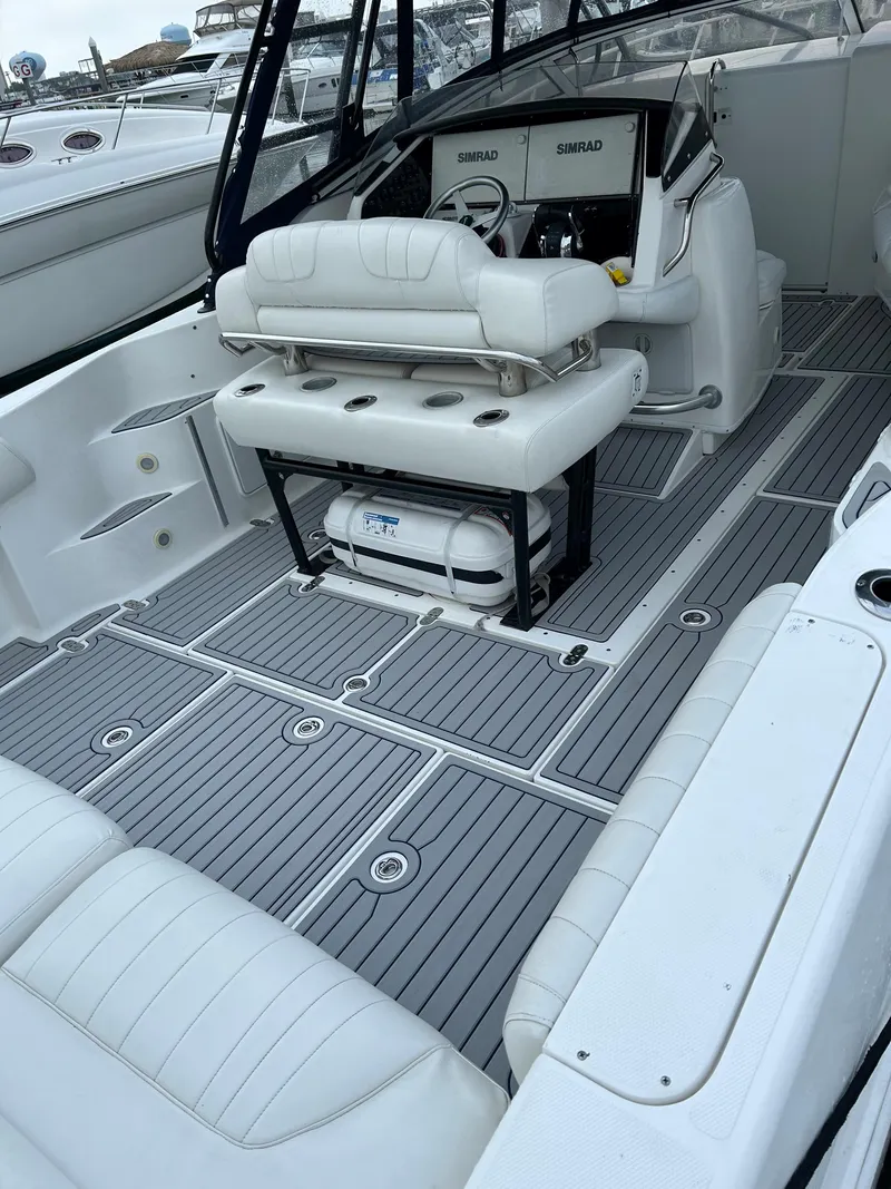 Slide: The Image of 2004 Fountain 38 LX boat interior with white seating and gray flooring. - 23