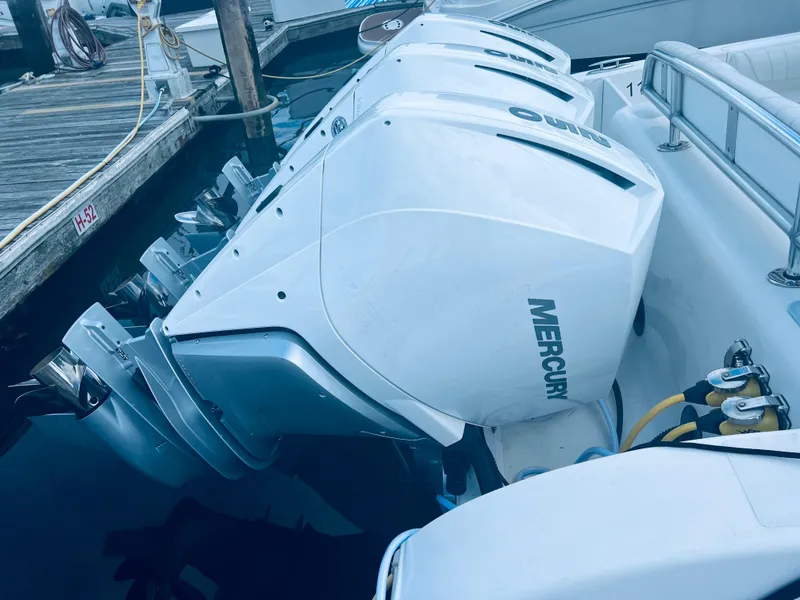 Slide: The Image of 2004 Fountain 38 LX boat with triple Mercury outboard engines docked. - 3