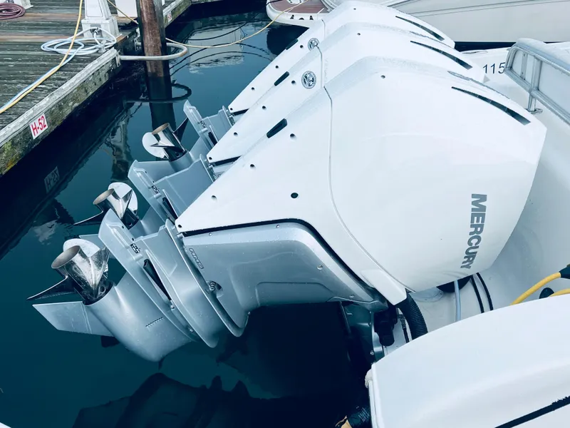 Slide: The Image of 2004 Fountain 38 LX boat with Mercury outboard engines at dock. - 8