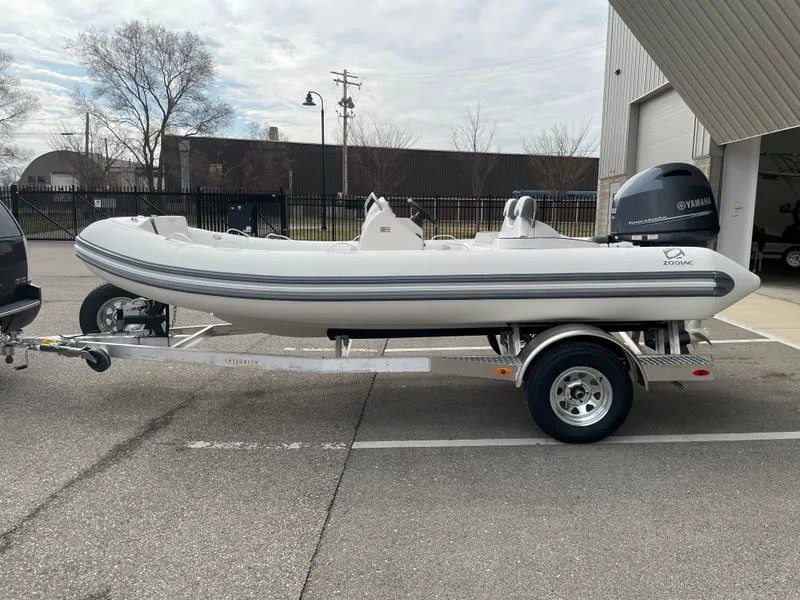 Slide: The Image of 2023 Zodiac Yachtline 490 Deluxe NEO 90hp on trailer, side view. - 3