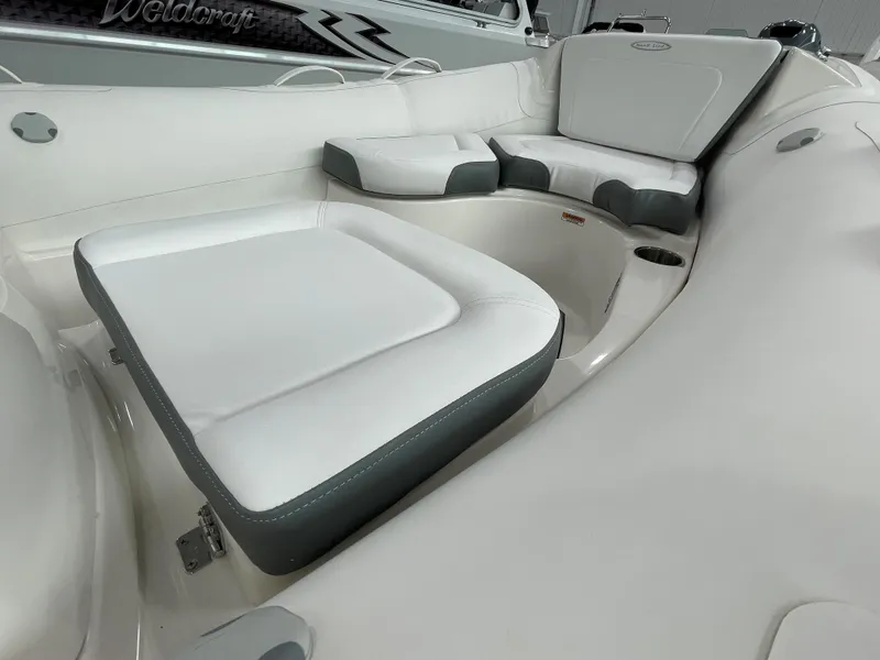 Slide: The Image of 2023 Zodiac Yachtline 490 Deluxe NEO 90hp boat interior with white and gray seating. - 23