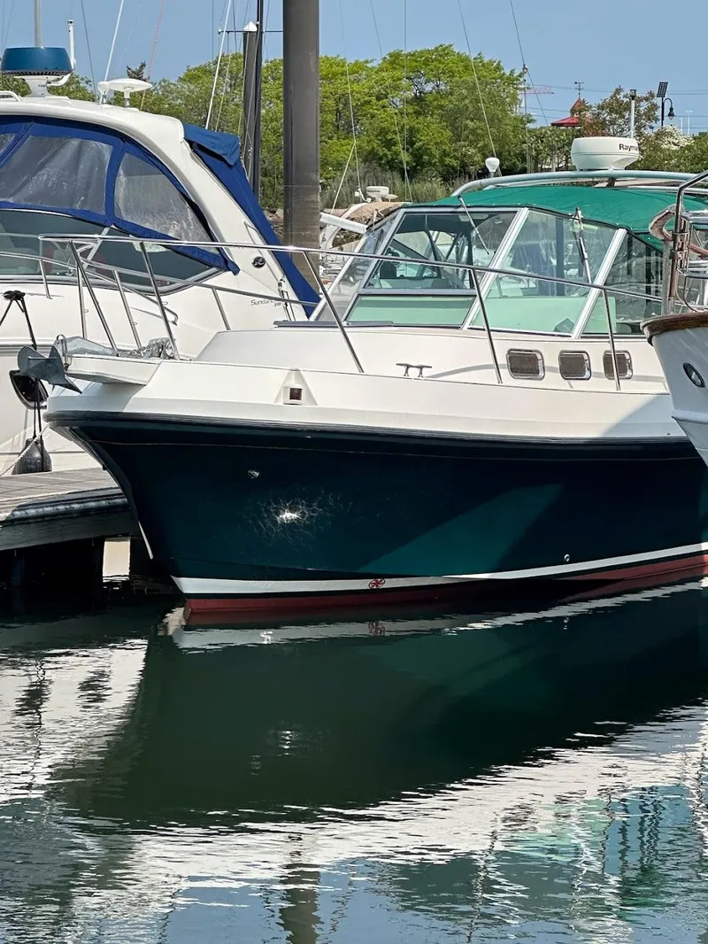 The Image of 2005 Albin 28 boat docked at marina, reflecting on calm water. - 0