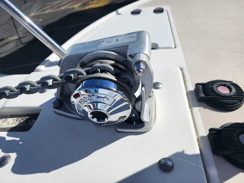 Slide: The Image of Anchor windlass on a 2005 Albin 28 boat deck, featuring a metal chain. - 6