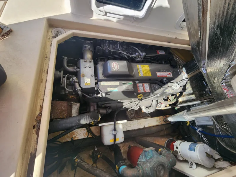 Slide: The Image of Engine compartment of a 2005 Albin 28 boat, showcasing mechanical components and wiring. - 7