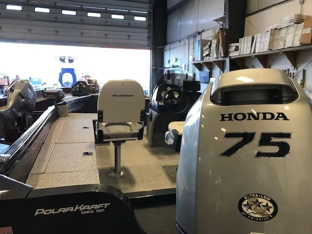 Slide: The Image of 2023 Polar Kraft Outlander 165 SC boat with Honda 75 engine in a garage. - 1