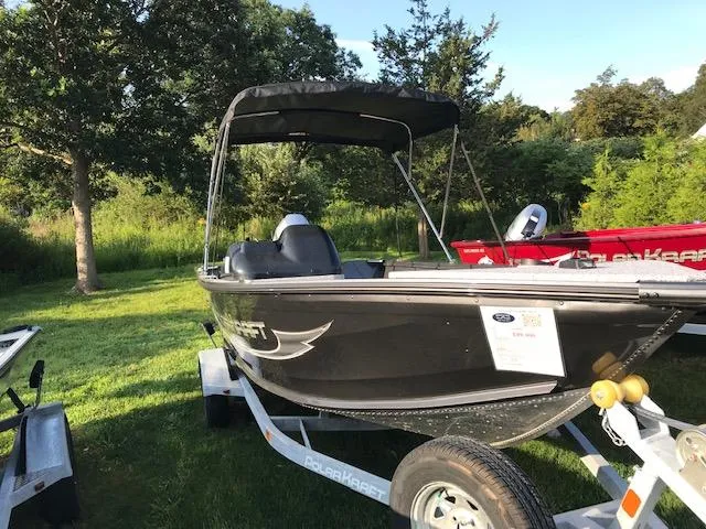 Slide: The Image of 2023 Polar Kraft Outlander 165 SC boat on trailer in grassy area. - 7