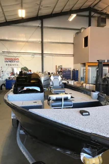 Slide: The Image of 2023 Polar Kraft Outlander 165 SC boat in a showroom. - 9