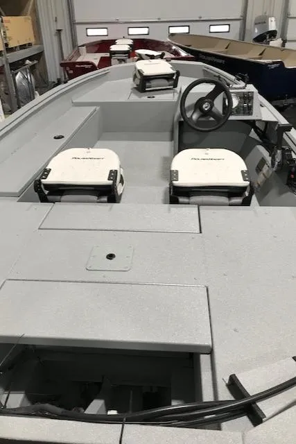 Slide: The Image of 2023 Polar Kraft Sport X boat interior with steering wheel and seating. - 8