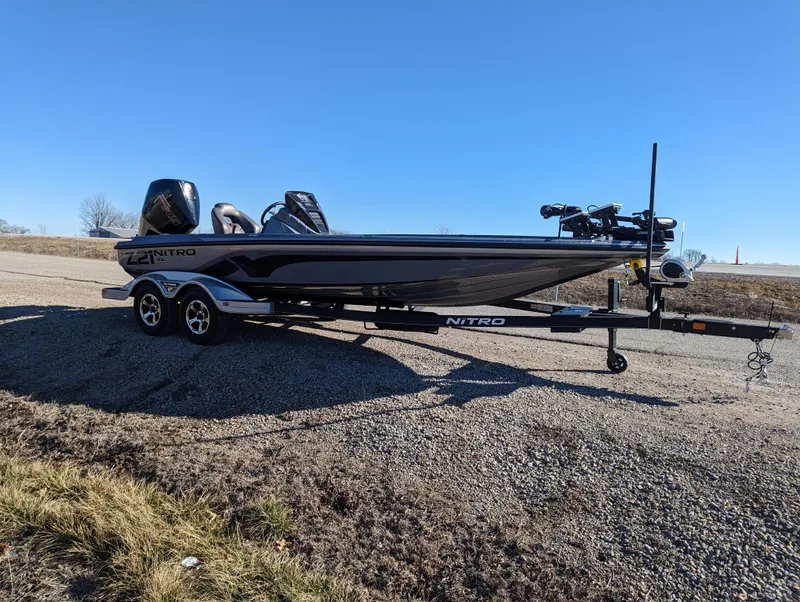 Slide: The Image of 2023 Nitro Z21 XL Pro boat on trailer under clear blue sky. - 9