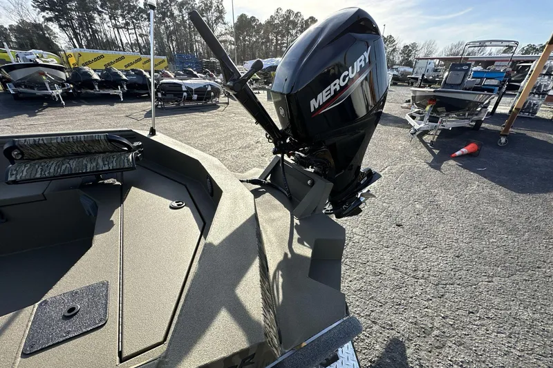 Slide: The Image of 2023 Thor Lake Hammer Elite boat with Mercury outboard motor in a dealership lot. - 9