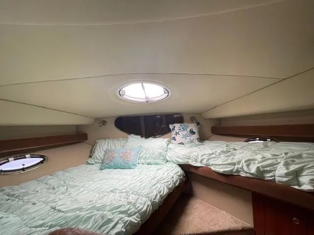 Slide: The Image of 2006 Cruisers Yachts 385 Motoryacht interior cabin with twin beds and porthole. - 13