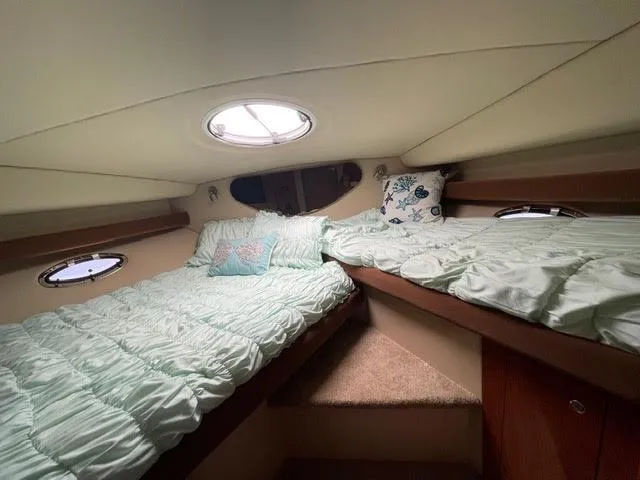 Slide: The Image of 2006 Cruisers Yachts 385 Motoryacht cabin with twin beds and porthole windows. - 15