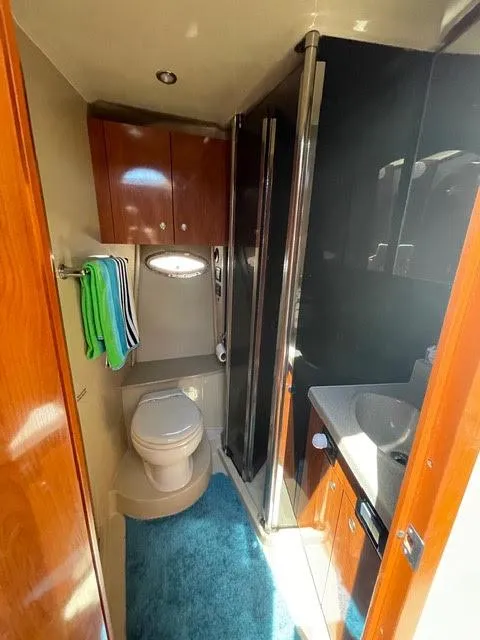 Slide: The Image of 2006 Cruisers Yachts 385 Motoryacht bathroom with toilet, sink, and shower. - 16