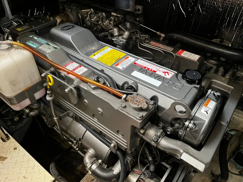 Slide: The Image of Engine compartment of a 2006 Cruisers Yachts 385 Motoryacht, showcasing detailed mechanical components. - 25