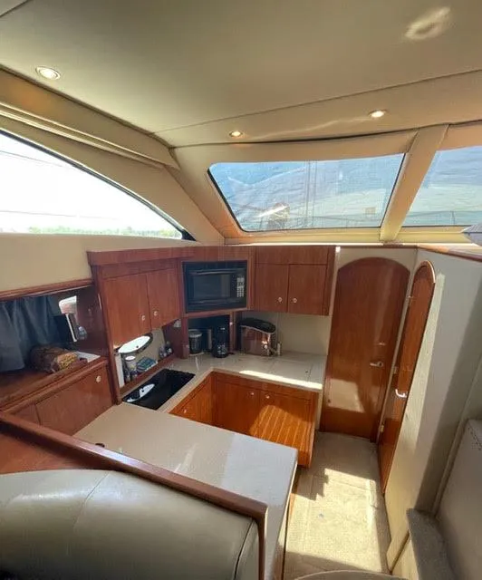 Slide: The Image of Interior of 2006 Cruisers Yachts 385 Motoryacht kitchen with wood cabinetry and modern appliances. - 6