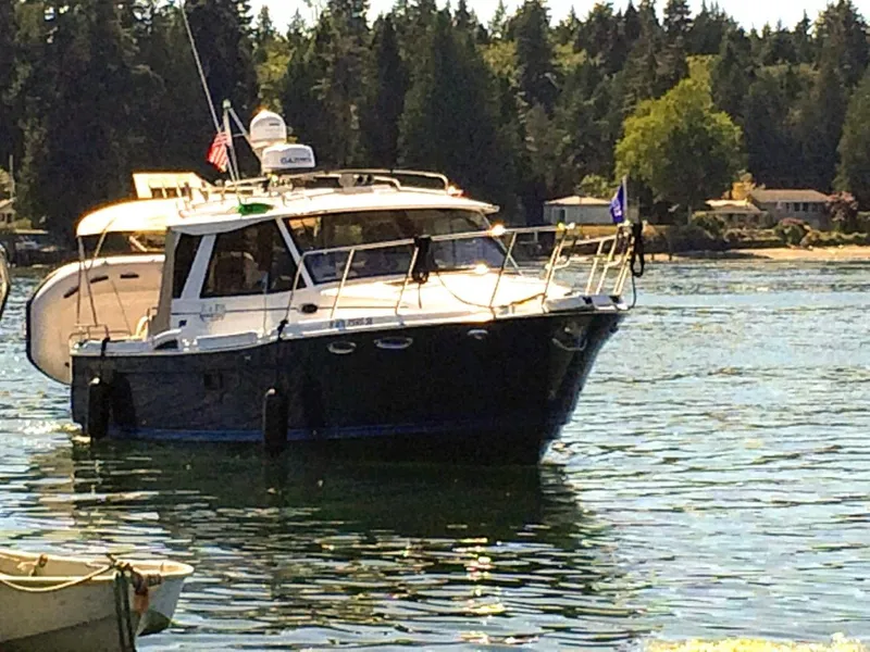Slide: The Image of 2017 Cutwater C-28 boat on calm water with forest backdrop. - 2