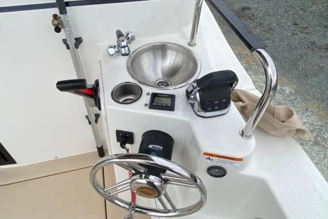 Slide: The Image of 2017 Cutwater C-28 boat helm with steering wheel, sink, and controls. - 4