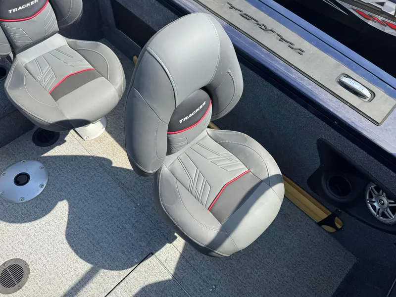 Slide: The Image of 2023 Tracker Targa V-18 WT boat interior with gray and red cushioned seats. - 13