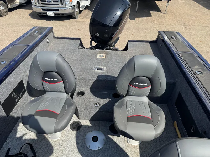 Slide: The Image of 2023 Tracker Targa V-18 WT boat interior with two gray seats and motor. - 14