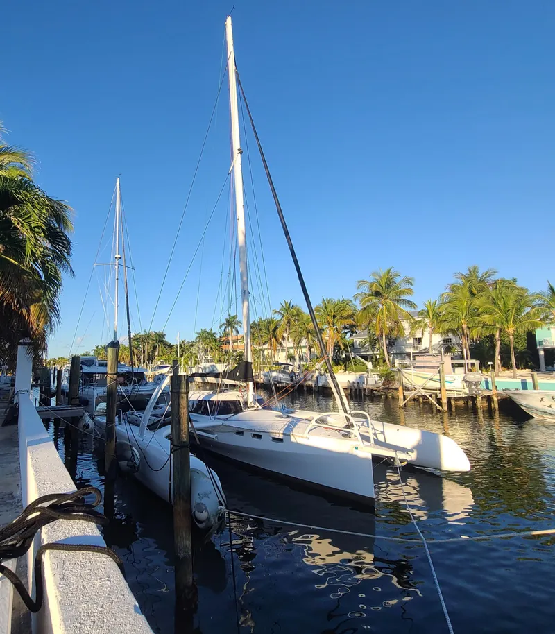 The Image of 2025 Rapido 40 sailboat docked in a sunny marina with palm trees. - 0