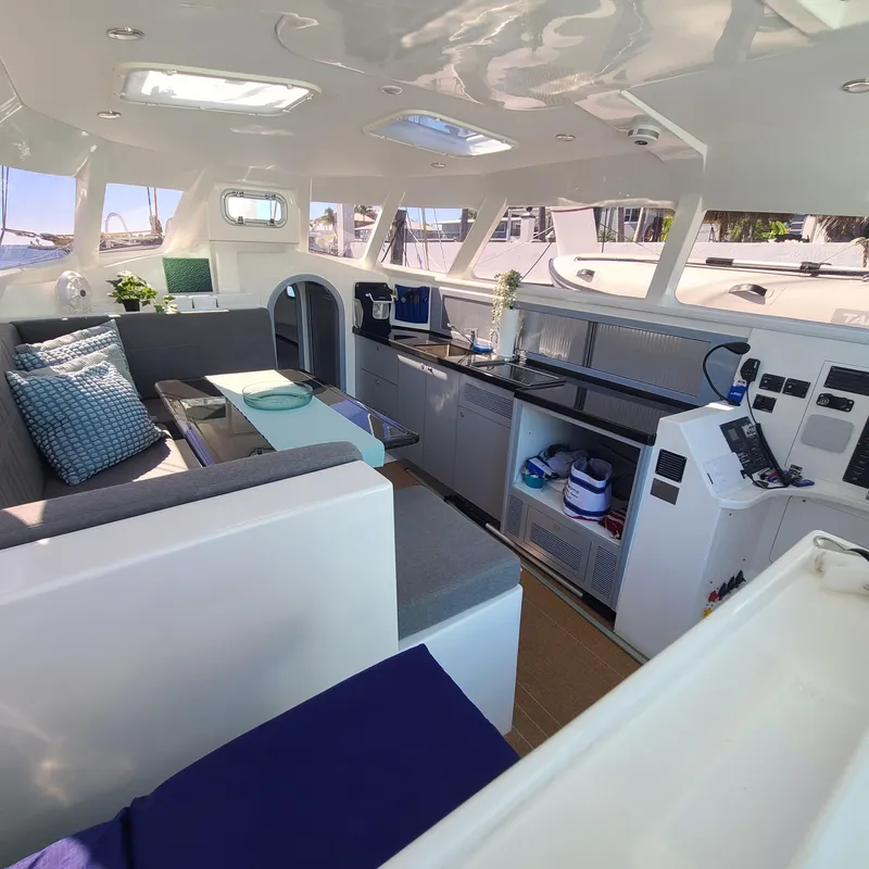 Slide: The Image of Luxurious interior of 2025 Rapido 40 catamaran with modern seating and kitchen area. - 11