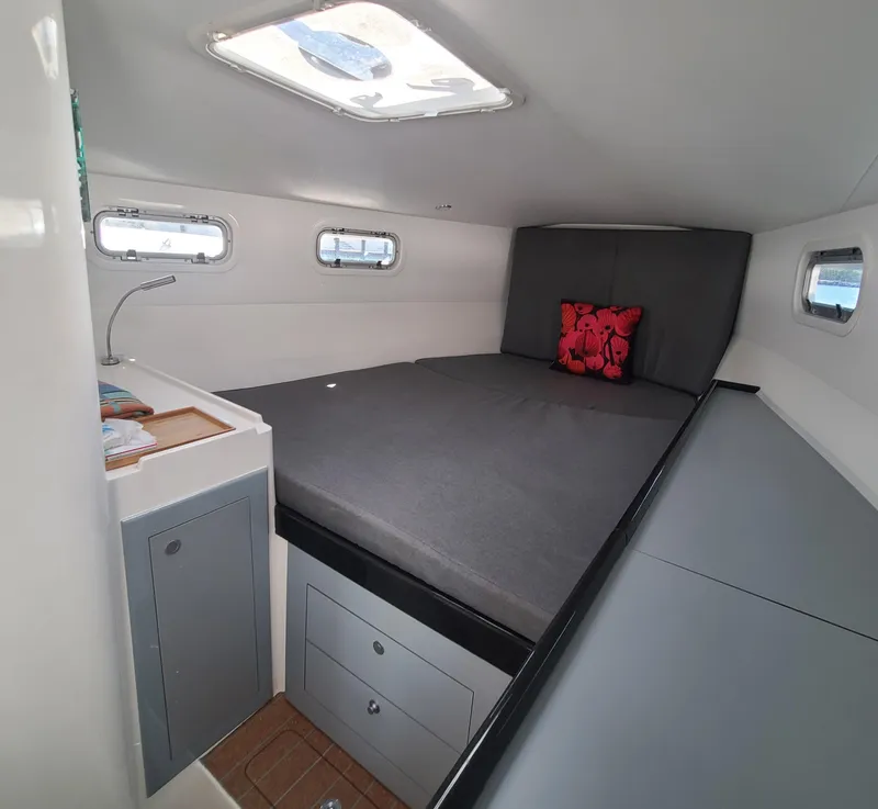 Slide: The Image of Cozy cabin interior of 2025 Rapido 40 yacht with bed, storage, and portholes. - 14