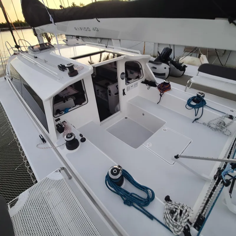 Slide: The Image of 2025 Rapido 40 sailboat deck with ropes and winches, docked at sunset. - 9