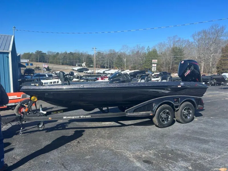 The Image of 2023 Ranger Z518 boat on a trailer in a parking lot. - 1