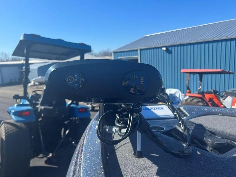 Slide: The Image of Close-up of 2023 Ranger Z518 boat control panel with tractors in the background. - 5