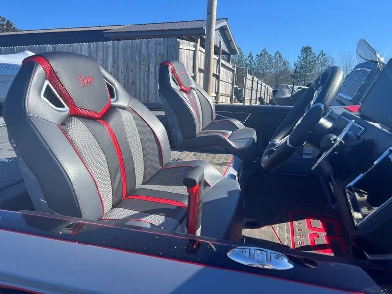 Slide: The Image of 2023 Ranger Z521R Cup Anniversary boat interior with red and gray seats. - 7