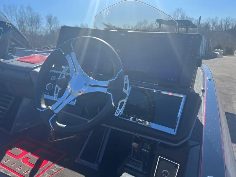 Slide: The Image of 2023 Ranger Z521R Cup Anniversary boat dashboard with steering wheel and electronic displays. - 8