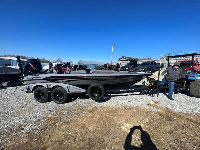 The Image of 2023 Ranger Z521R Cup Anniversary boat on a trailer in a gravel lot. - 1