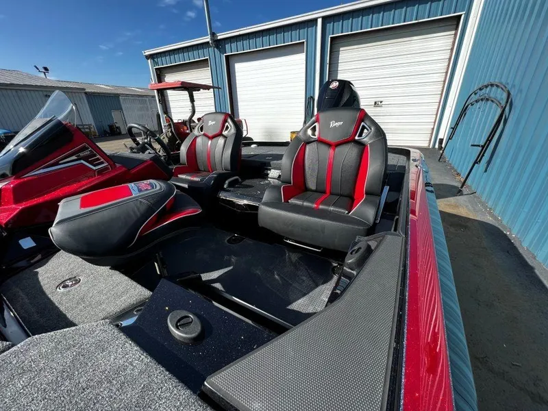 Slide: The Image of 2023 Ranger Z520R Ranger Cup Equipped boat with red and black seats in a storage facility. - 28
