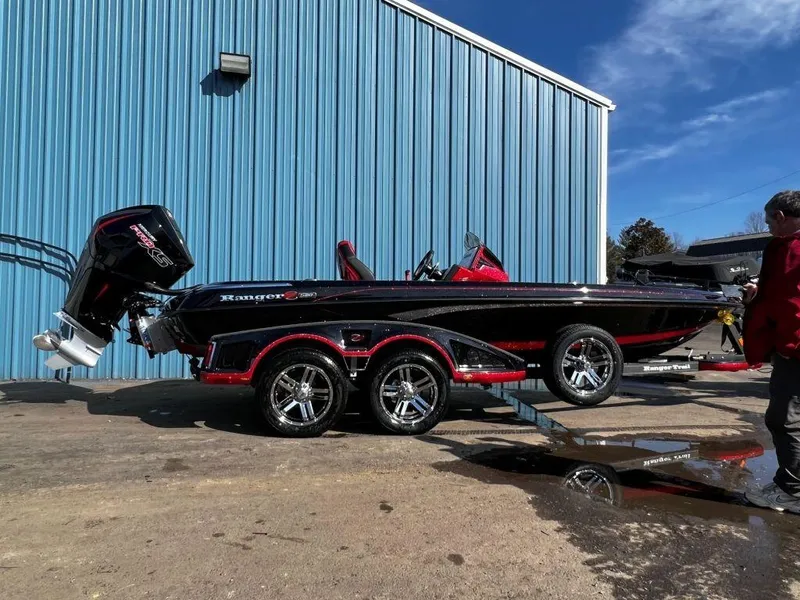 Slide: The Image of 2023 Ranger Z520R Ranger Cup Equipped boat on trailer outside blue building. - 3